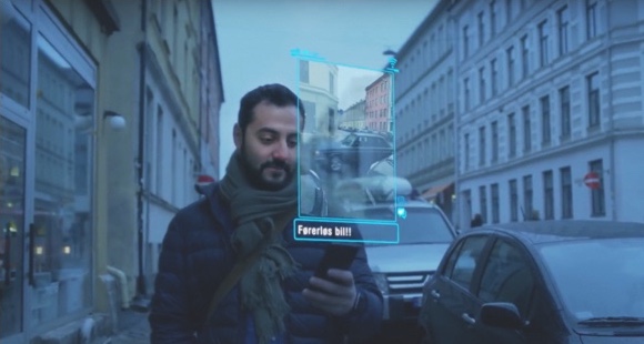 Image of man holding phone with projected view of his screen.